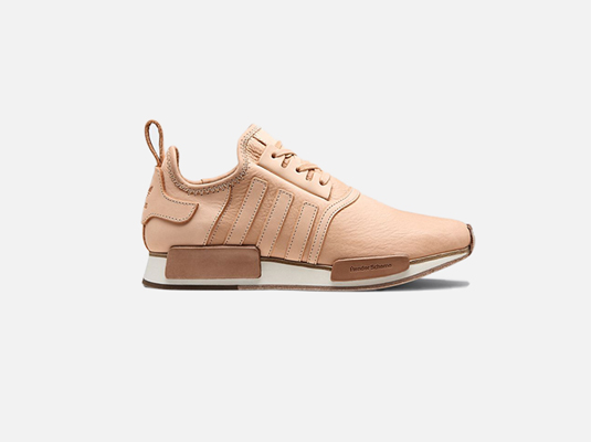 The image shows a single, light beige Adidas NMD R1 sneaker, crafted from what appears to be  high-quality, possibly vegetable-tanned leather.  The shoe is presented in profile view against a plain white background. The 'Pendleton Scheme' branding is visible on the sole.  The overall aesthetic is minimalist and refined, suggesting a focus on premium materials and craftsmanship.