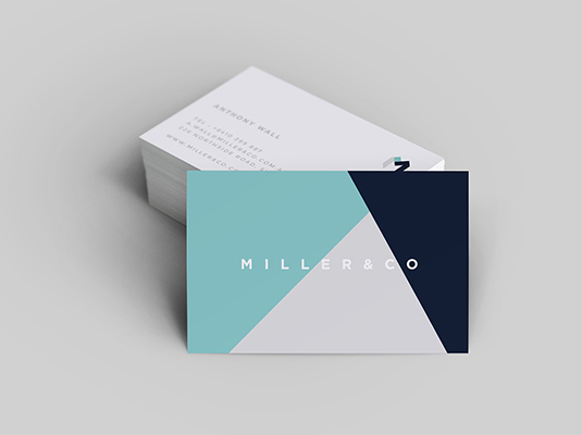 The image showcases a sleek and modern business card design that captures attention through its geometric patterns and color palette. The front of the card prominently features the name MILLER&CO in bold, uppercase letters, rendering a sense of professionalism and clarity. The background is divided into distinct sections: a tranquil teal triangle contrasts sharply with a deep navy section, creating a visually appealing balance. This juxtaposition may evoke feelings of innovation and creativity, suggesting that the
                                company values both aesthetic appeal and structured design. The reverse side, partially visible, appears minimalist and likely contains essential contact information in a clean and straightforward layout. This simplicity complements the front design, reflecting a brand that appreciates elegance without unnecessary clutter. Overall, the combination conveys a modern brand identity that could resonate well in professional environments.