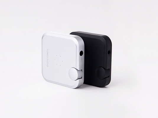 In this image, I designed a minimalistic scene featuring two compact devices positioned closely together, one in a sleek silver finish and the other in a matte black. Both devices share a square shape, giving them a modern, streamlined appearance. The subtle detailing, such as a small illuminated button and a couple of indicator lights, hints at their functionality while maintaining an uncluttered aesthetic. The juxtaposition of the light and dark colors symbolizes balance and contrast—perhaps representing the duality of utility and design. This visual pairing could evoke themes of choice, highlighting how different preferences in color can influence consumer decisions. The overall simplicity reflects current trends in technology aesthetics, promoting a sense of sophistication and ease of use. The image encourages viewers to think about the relationship between form and function in everyday technology, inspiring reflections on how design can impact our interaction with devices.