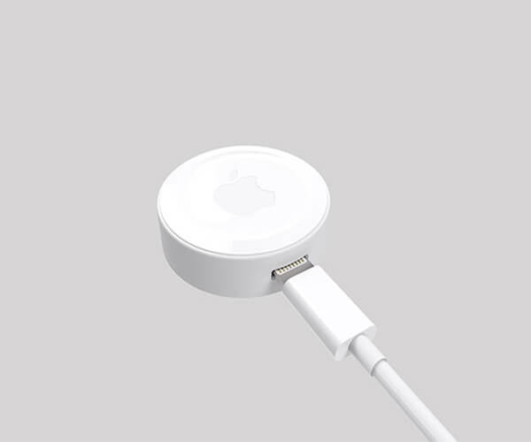 The image shows a white Apple device, possibly a charging puck or a similar accessory, connected to a white USB-C cable.  The device has the Apple logo subtly imprinted on its top surface. The overall aesthetic is minimalist and clean.